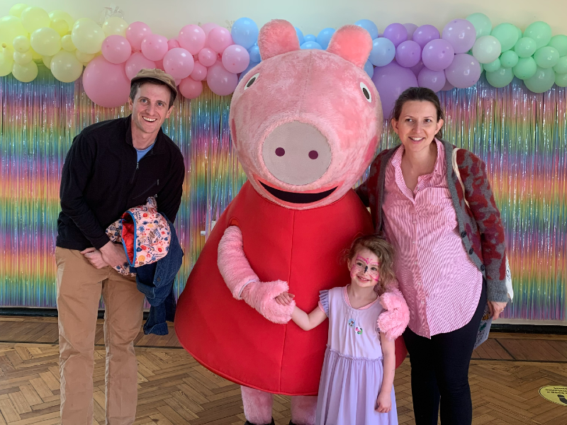 Peppa Pig with a family at the Peppa Pig flu clinic